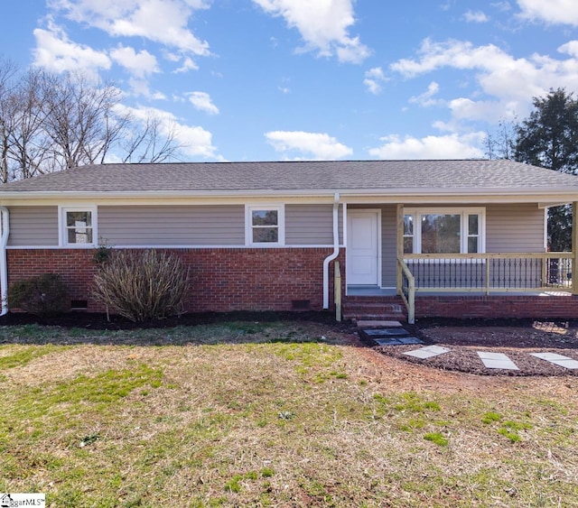 single story home with brick siding, a shingled roof, a porch, a front yard, and crawl space