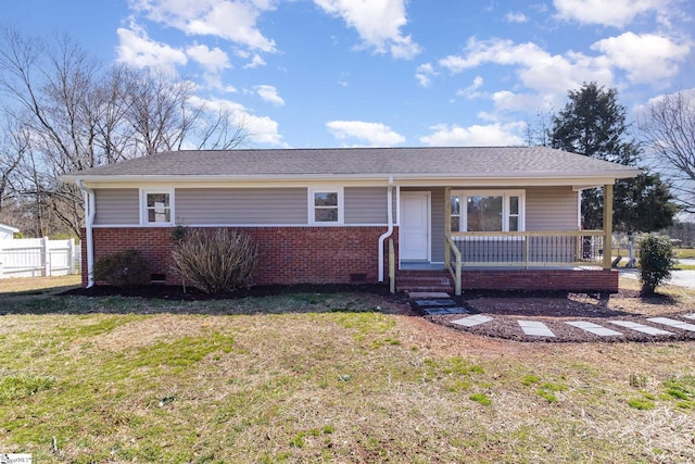 view of front facade featuring fence, covered porch, a front lawn, crawl space, and brick siding