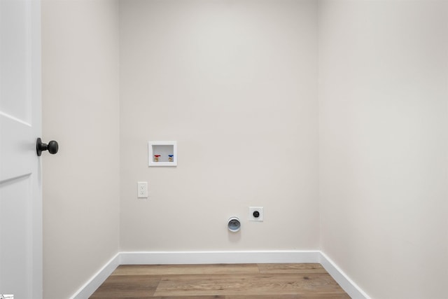 laundry room with baseboards, laundry area, electric dryer hookup, washer hookup, and light wood-type flooring