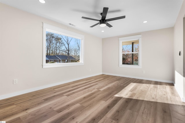 unfurnished room featuring recessed lighting, visible vents, baseboards, and wood finished floors