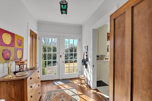 doorway with french doors, crown molding, and hardwood / wood-style flooring