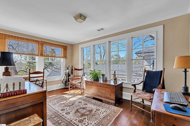 home office with hardwood / wood-style floors, visible vents, baseboards, and ornamental molding