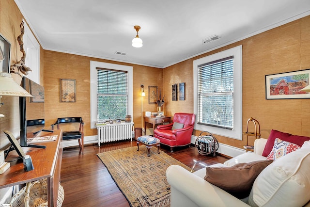 interior space with visible vents, a healthy amount of sunlight, and radiator heating unit