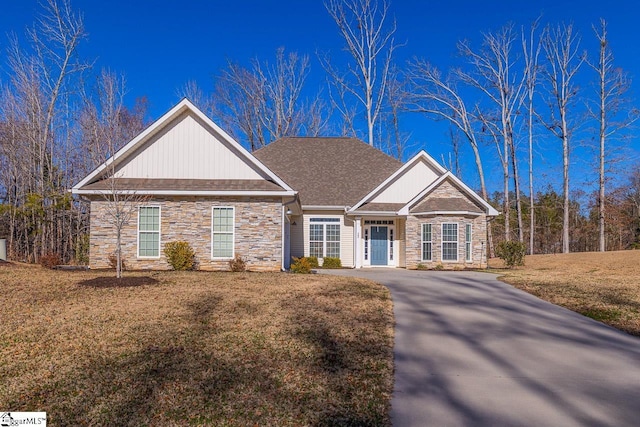 view of front of house with stone siding and a front yard