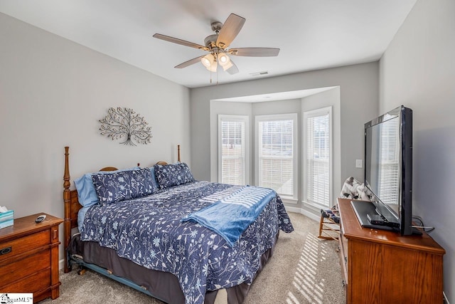 bedroom with carpet flooring, a ceiling fan, and visible vents