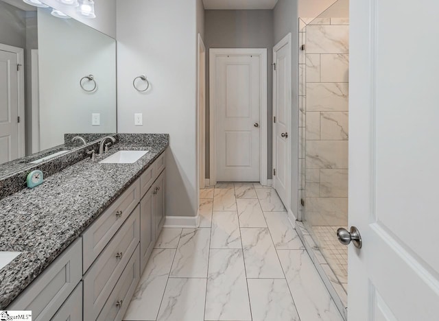 bathroom featuring marble finish floor, vanity, and baseboards