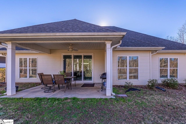 back of house featuring a patio, a yard, roof with shingles, and ceiling fan