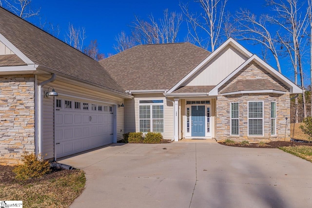 view of front of property with concrete driveway, an attached garage, stone siding, and a shingled roof