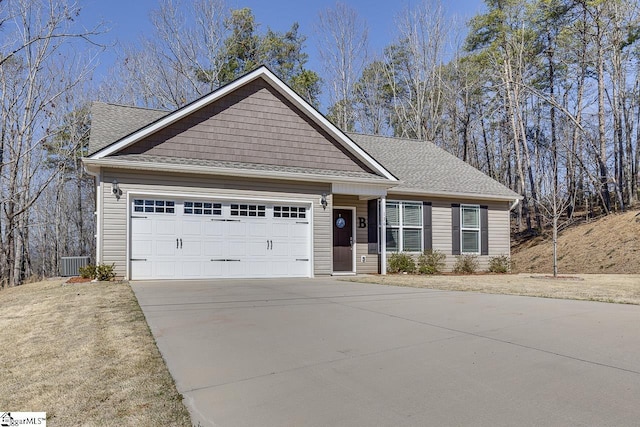 view of front of house with central AC unit, a garage, driveway, and roof with shingles