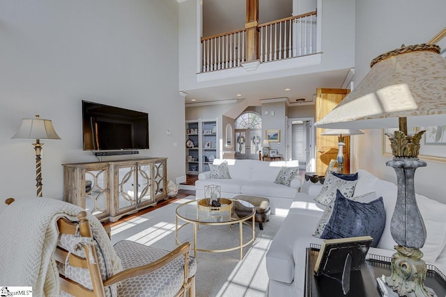 living room featuring recessed lighting, a high ceiling, and wood finished floors