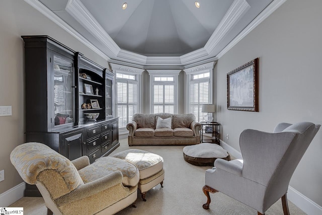 carpeted living room featuring lofted ceiling, a raised ceiling, crown molding, and baseboards