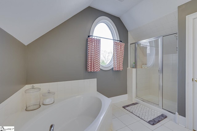 full bath featuring vaulted ceiling, a garden tub, tile patterned floors, and a shower stall