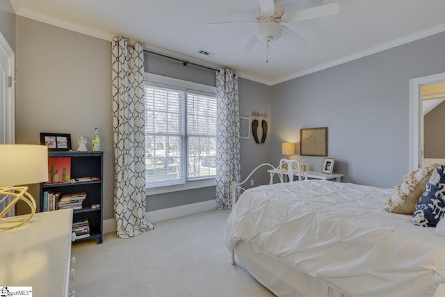 carpeted bedroom featuring visible vents, baseboards, ceiling fan, and crown molding