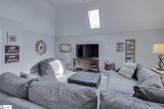 living area featuring a skylight, baseboards, and visible vents