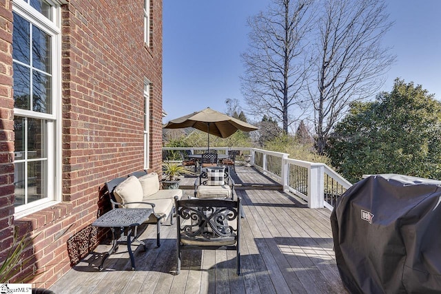 wooden terrace featuring an outdoor living space and area for grilling