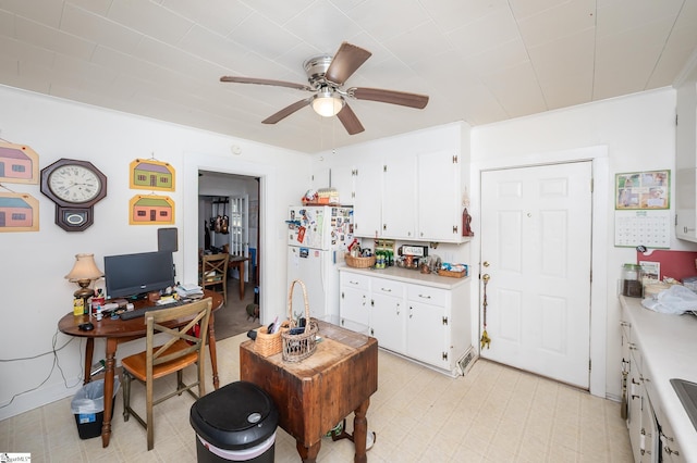 interior space featuring light floors and a ceiling fan