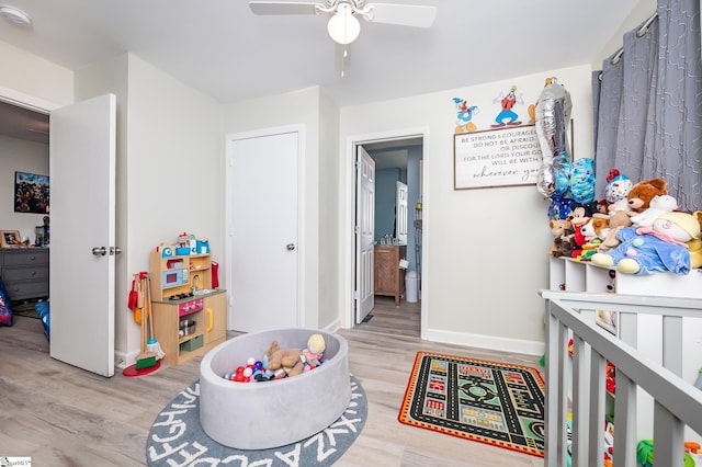 rec room with a ceiling fan, light wood-type flooring, and baseboards