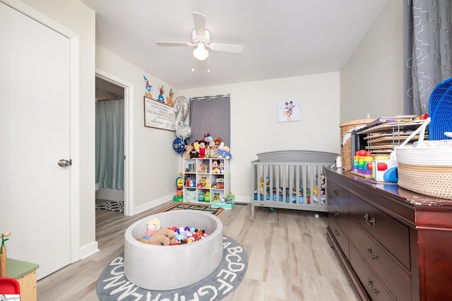 bedroom with baseboards, wood finished floors, and a ceiling fan