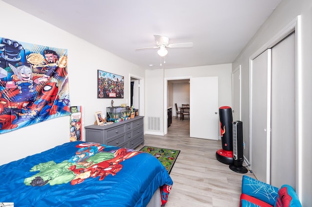 bedroom featuring a closet, visible vents, ceiling fan, and wood finished floors