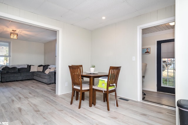 dining space featuring light wood-type flooring