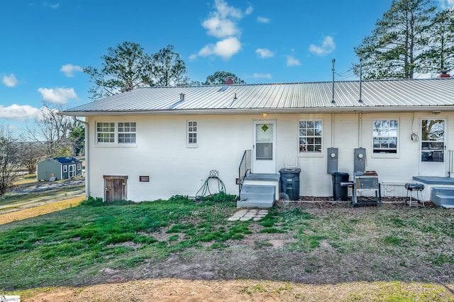 rear view of house featuring metal roof