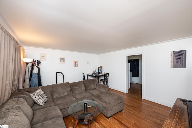 living room featuring baseboards and wood finished floors