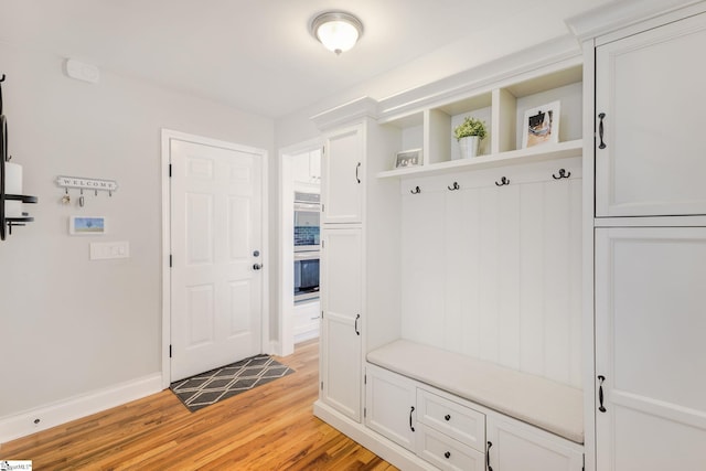 mudroom featuring baseboards and light wood-style flooring