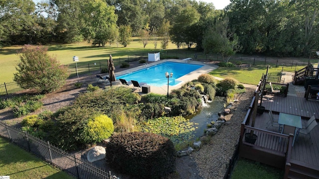 view of swimming pool featuring a fenced in pool, a lawn, and fence