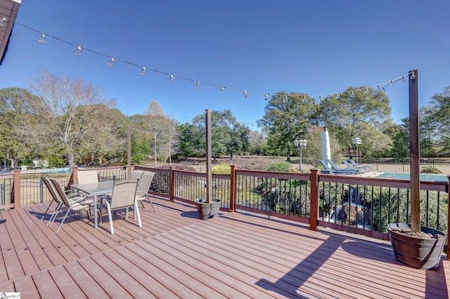 deck featuring outdoor dining space and fence