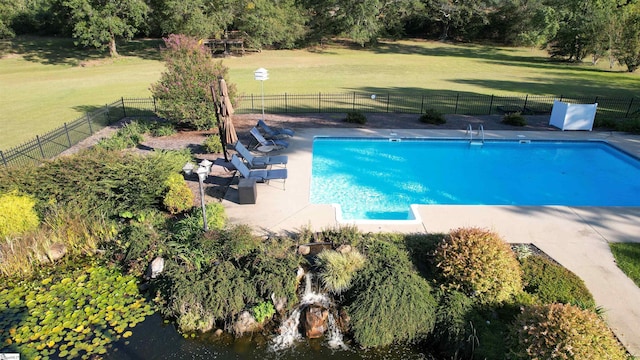 view of pool with a lawn, fence, and a fenced in pool