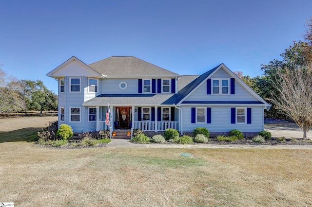 view of front of property featuring roof with shingles, a porch, and a front yard