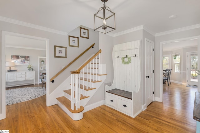 staircase with baseboards, wood finished floors, and crown molding