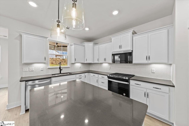 kitchen featuring a sink, backsplash, gas range, white cabinets, and stainless steel dishwasher