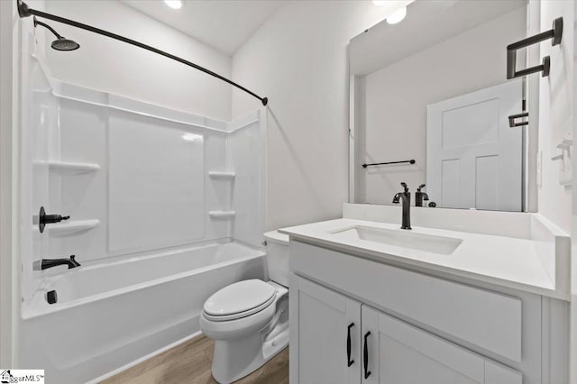 full bathroom with vanity, toilet, wood finished floors, and tub / shower combination