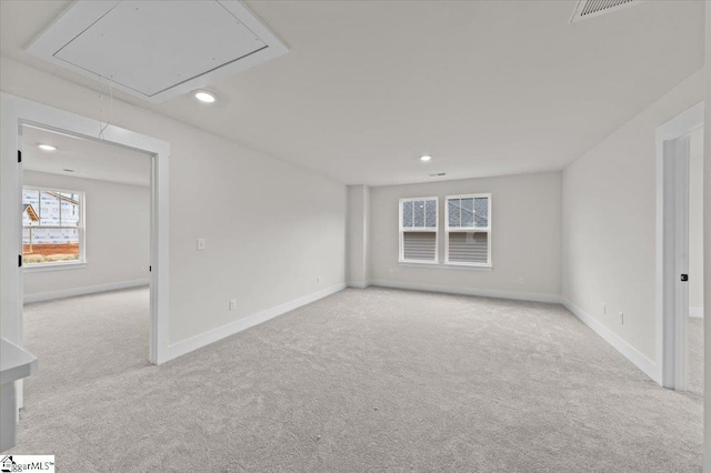 unfurnished room featuring carpet flooring, recessed lighting, and attic access