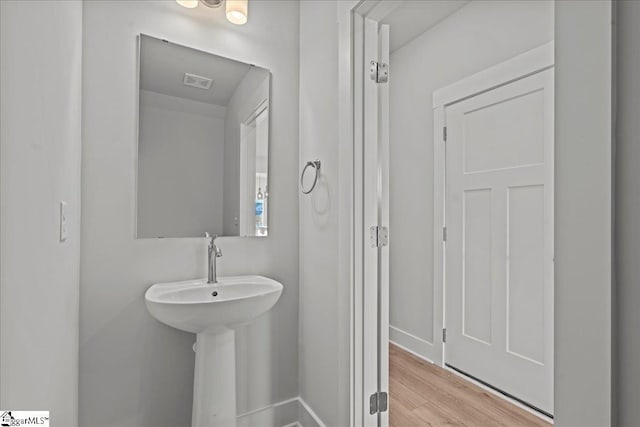 bathroom with wood finished floors and visible vents