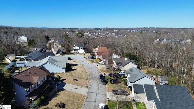 birds eye view of property featuring a residential view and a view of trees