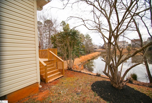 view of yard with stairway and a water view