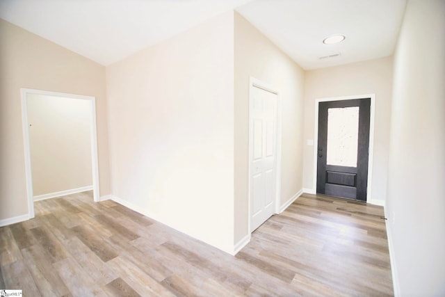 foyer with wood finished floors and baseboards