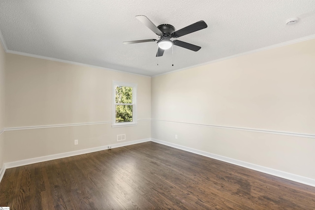 spare room with visible vents, dark wood-type flooring, ornamental molding, and a textured ceiling