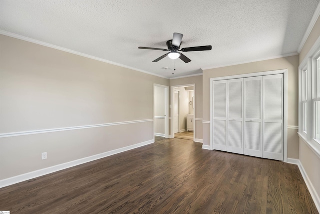 unfurnished bedroom with ornamental molding, a textured ceiling, wood finished floors, a closet, and baseboards