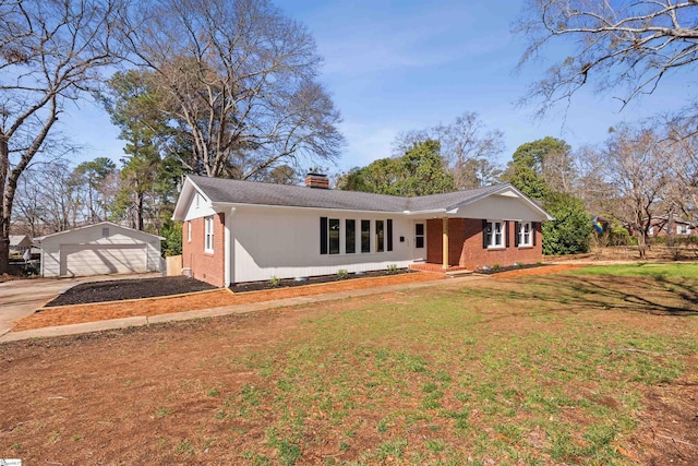 ranch-style house featuring a front yard, brick siding, an outdoor structure, and a chimney