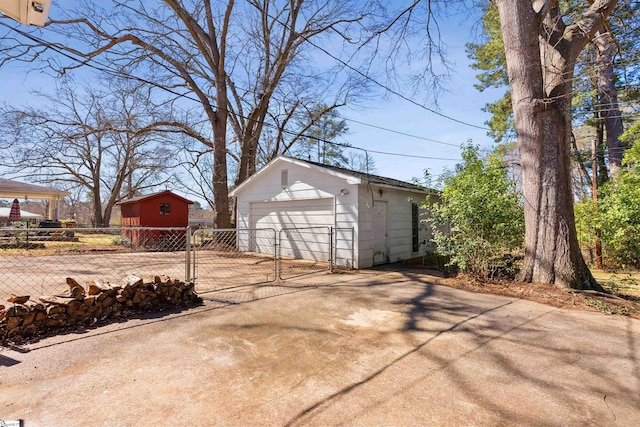 detached garage featuring a gate and fence