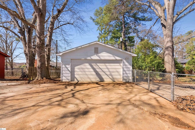 detached garage featuring a gate and fence