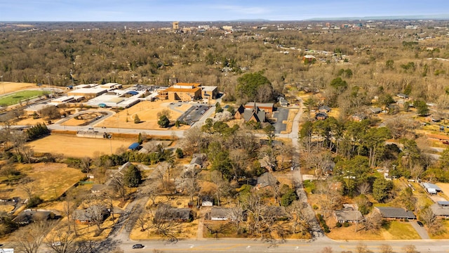 bird's eye view with a wooded view