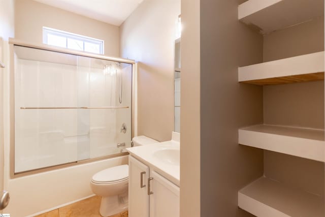 bathroom with shower / bath combination with glass door, toilet, vanity, and tile patterned floors