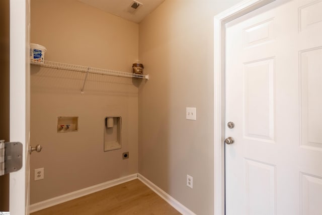 clothes washing area featuring visible vents, baseboards, washer hookup, laundry area, and hookup for an electric dryer