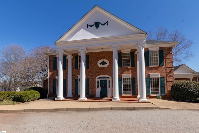 greek revival house featuring brick siding