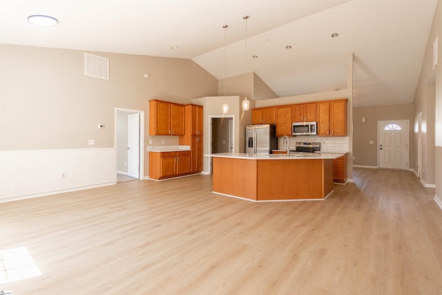 kitchen featuring a sink, stainless steel appliances, visible vents, and light countertops