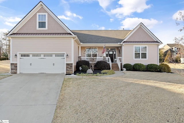 craftsman inspired home featuring driveway, a standing seam roof, covered porch, a garage, and metal roof